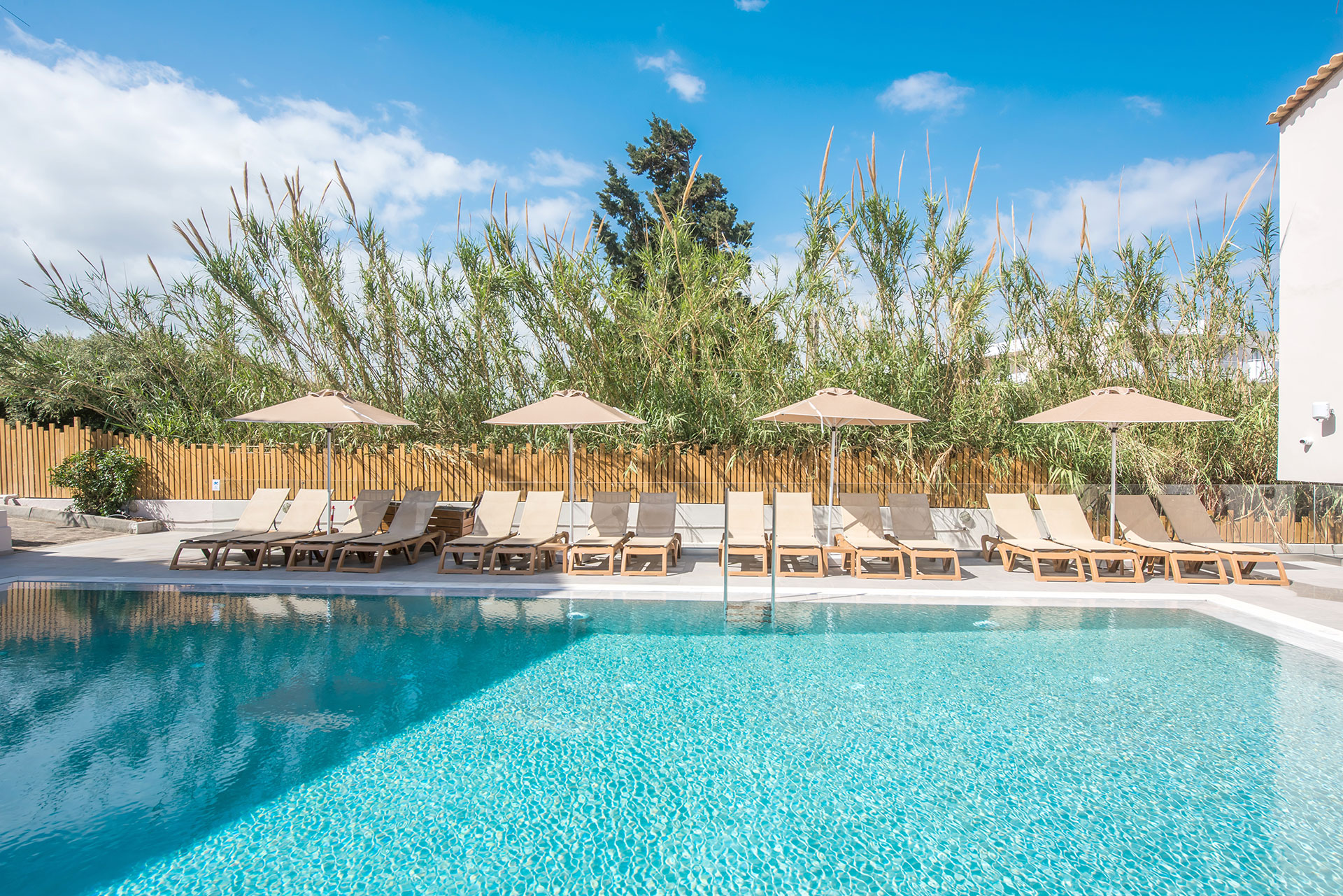 Outdoor swimming pool with sun loungers and umbrellas at Gouves Water Park Holiday Resort