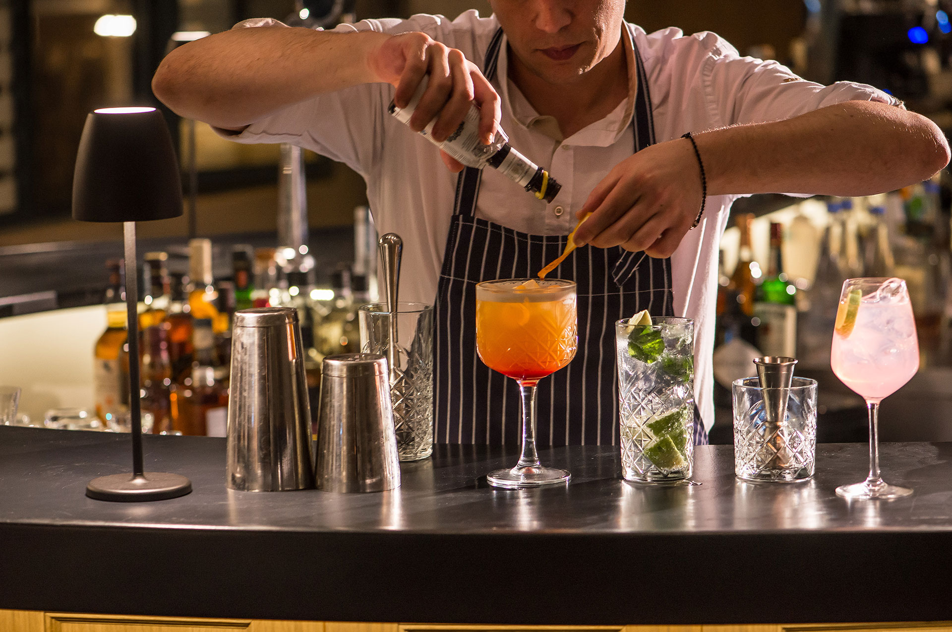 Bartender preparing assorted cocktails at the bar of Gouves Water Park Holiday Resort