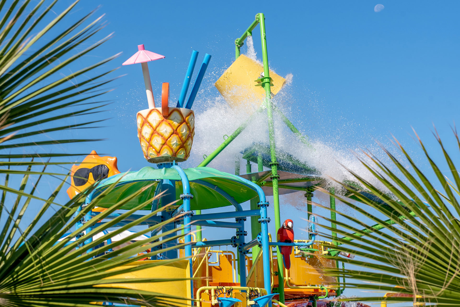 Close-up splash park with colourful slides and the water bucket pouring over the play area at Gouves Water Park Holiday Resort