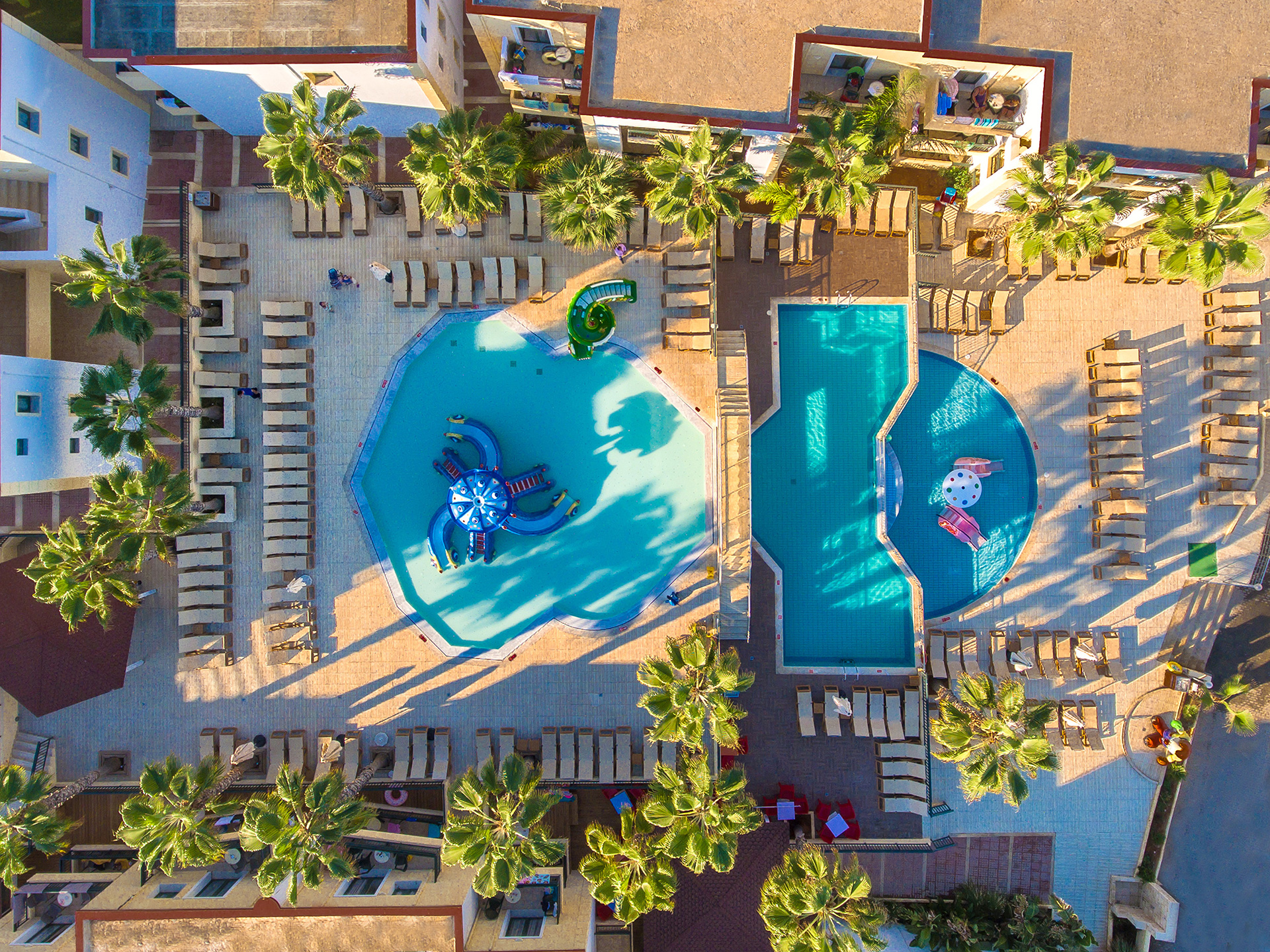 Top-down wide view of the mini water park with three levels of children’s pools and slides at Gouves Water Park Holiday Resort