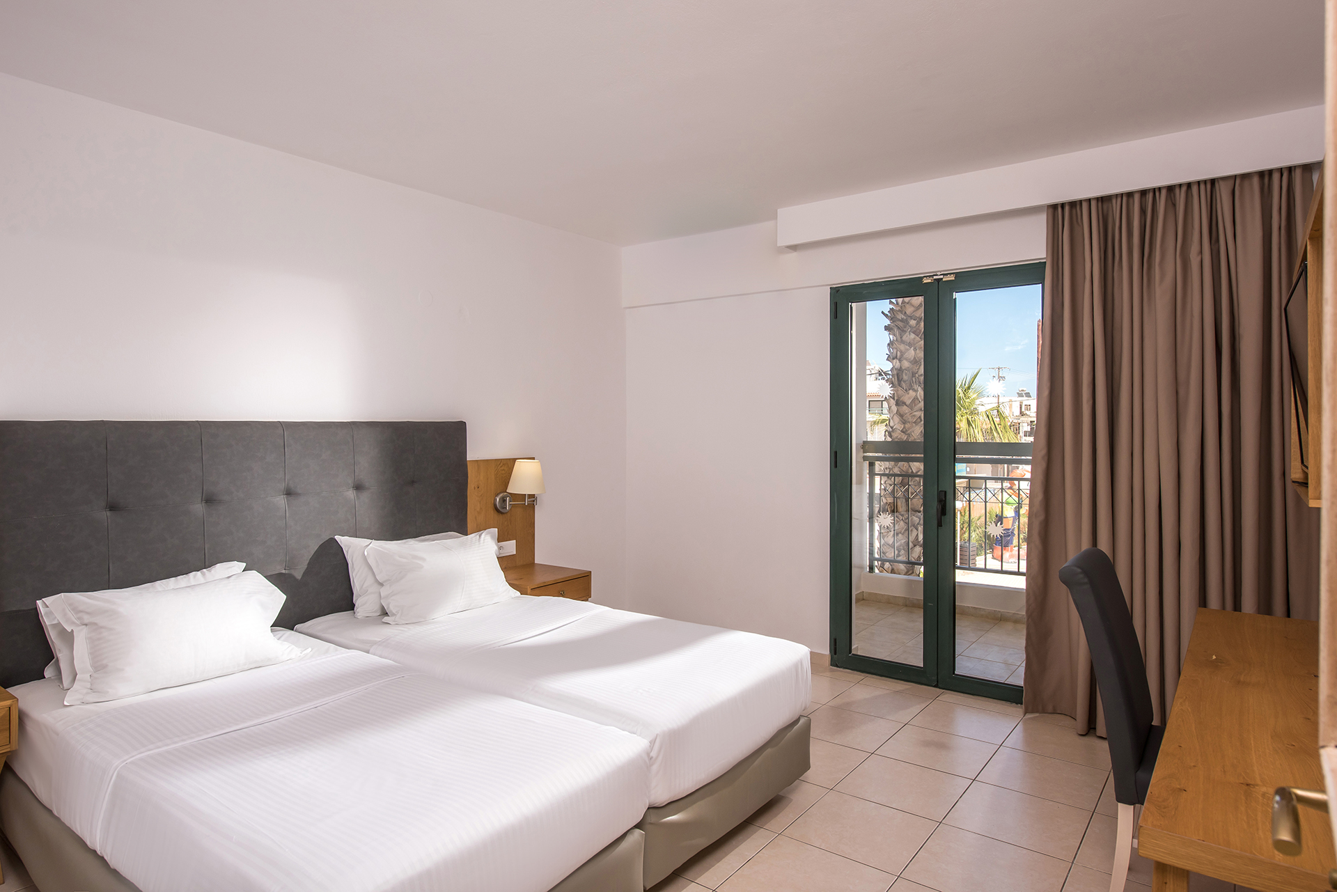 Contemporary family room with twin beds, air conditioning and private balcony at Gouves Water Park Holiday Resort
