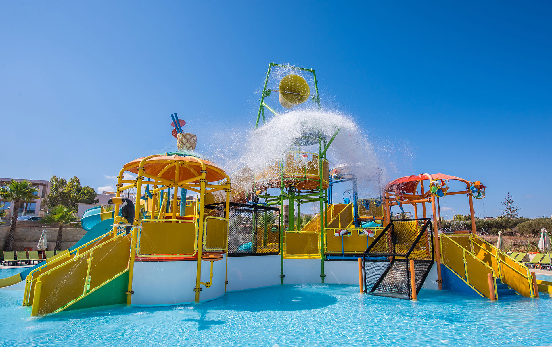 Wide splash park view with colourful slides and water play structures at Gouves Water Park Holiday Resort