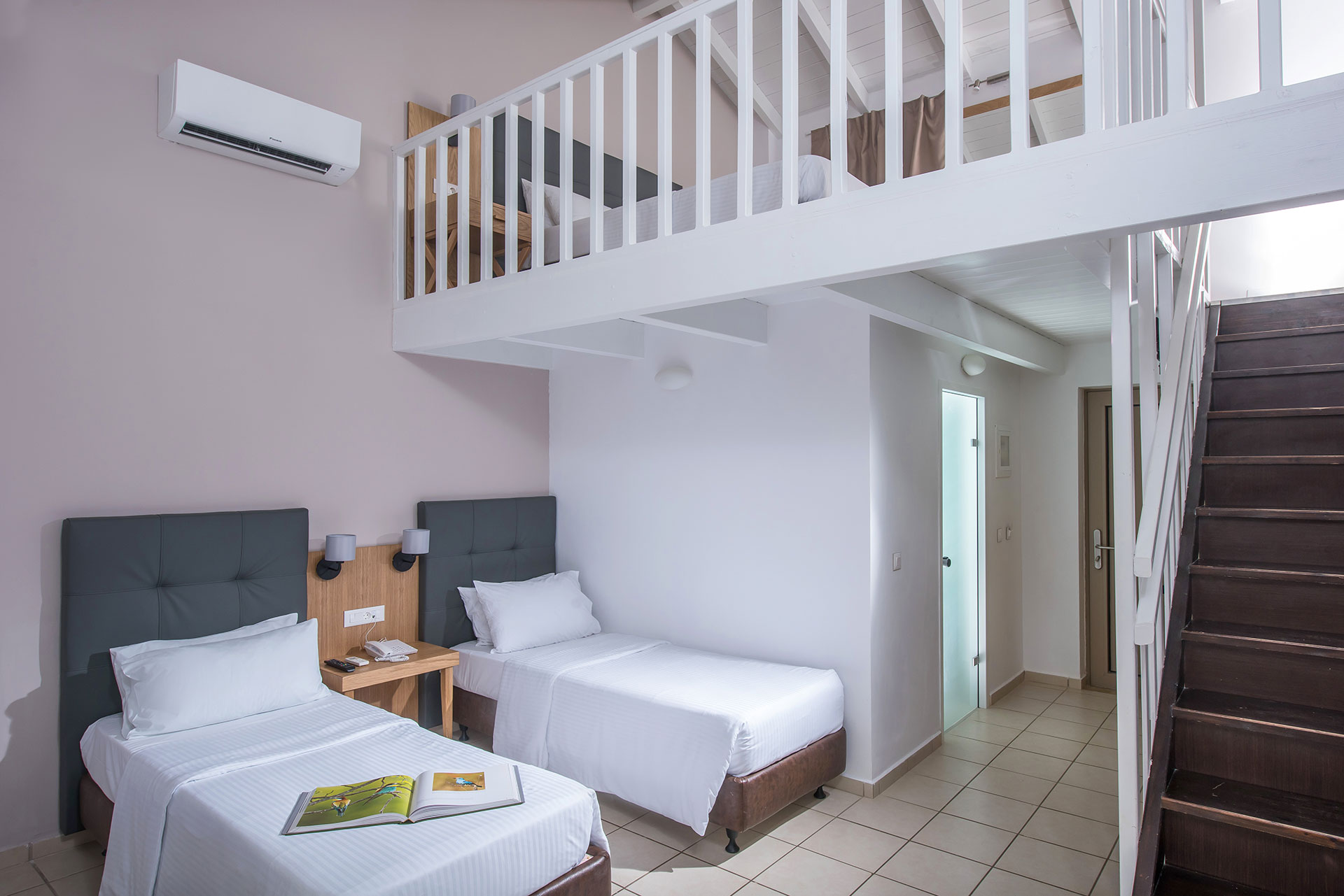 Two-level maisonette with twin beds downstairs and loft bedroom at Gouves Water Park Holiday Resort