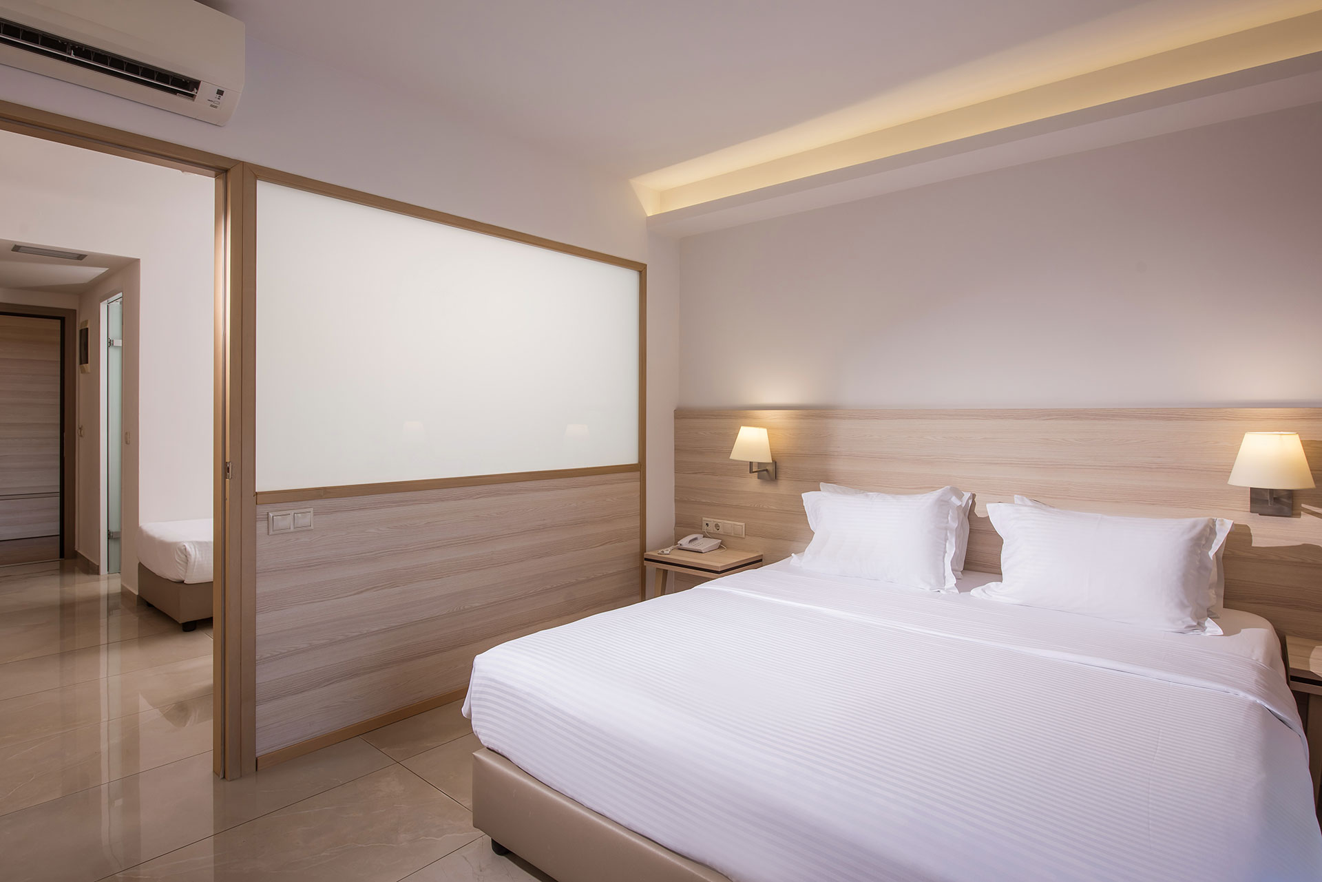 Separate bedroom in family suite with double bed and modern décor at Gouves Water Park Holiday Resort